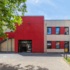 Schulhofansicht mit Anbau, Außentreppe und farbiger Fassade der Gesamtschule Uerdingen
